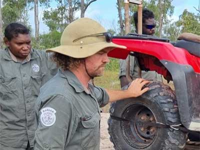 Rangers beside a quad bike