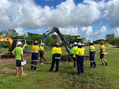 Trainees watching a prestart inspection of an excavator